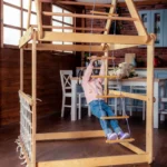 indoor-wooden-playhouse-with-triangle-ladder-slide-board-and-swings-691041